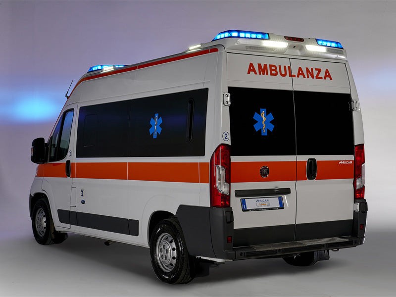 Ambulance with blue and white rood flashing lights