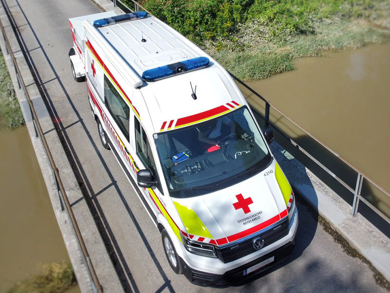 Red cross ambulance with blue lightbars